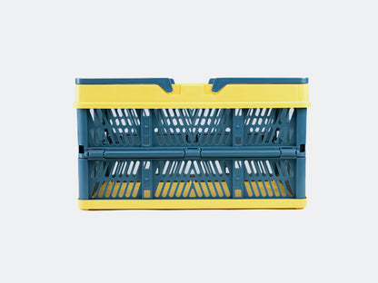 Velowave_Blue and yellow folding crate/basket on a light gray background