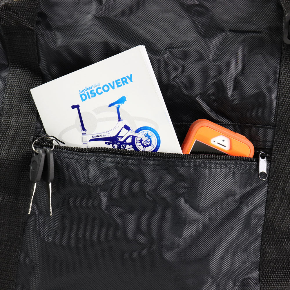 JupiterBikes_Black Bike Bag with a pocket containing a white instruction manual with blue graphics and text, an orange item, and keys.
