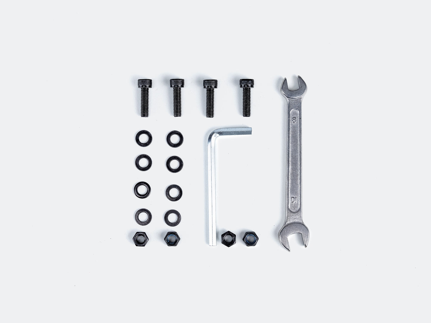 Velowave_Set of tools for assembling rear rack and includes screws, bolts, and wrenches on a white background