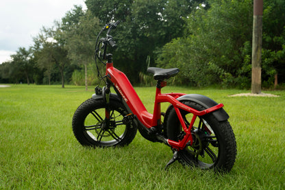 velowave_Red Pony electric bike on grass with trees in the background